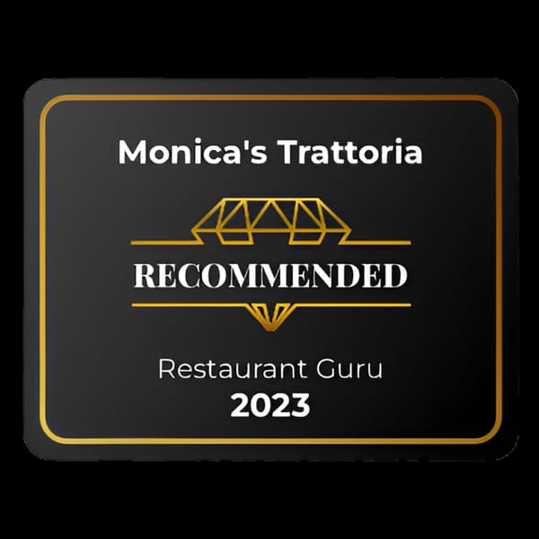 Monica's Trattoria Restaurant Guru Recommended 2023 award badge, black with gold trim.
